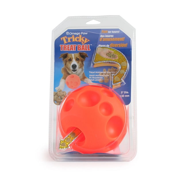 Omega Paw Small 2.8-inch Tricky Treat Ball dispensing dog toy in bright orange soft vinyl with craters and dimples, packaged with a blue card showing a dog and treat dispensing instructions, designed to entertain dogs and slow feeding.