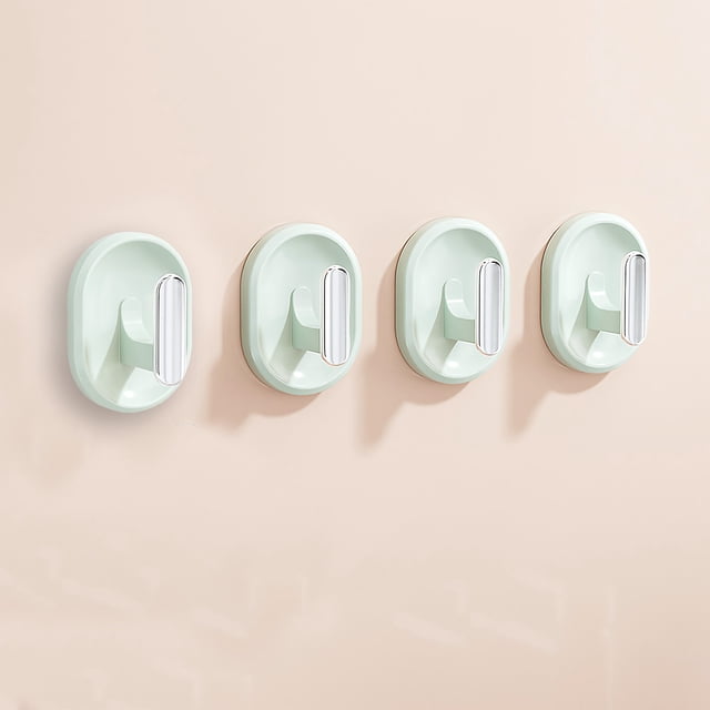 TopLLC No Punch Hooks for kitchen, bathroom, and living room shown in a set of four. These adhesive hooks are oval-shaped, made of green plastic with a sleek white backing for damage-free installation. Designed for easy use without drilling, they securely attach to surfaces like painted walls, tiles, and glass. Ideal for hanging hats, clothes, or accessories in wet or dry environments.