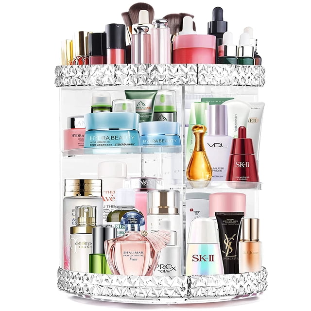 360° Rotating Makeup Organizer made of clear acrylic with diamond design edges on the top and bottom. Features multiple adjustable layers for customizable storage of cosmetics, brushes, lipsticks, and skincare products. Reinforced base rotates smoothly and silently, providing easy access to items. Ideal for vanities, countertops, and desks, and doubles as a makeup display case.