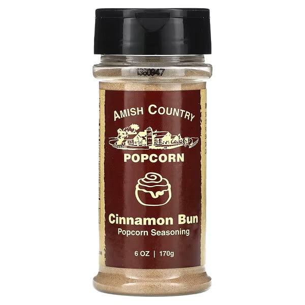 Amish Country Popcorn, Popcorn Seasoning, Cinnamon Bun, 6 oz (170 g) front-facing clear jar of tan cinnamon-bun powdered seasoning with cream label and brown lid on a kitchen surface, presented as a sweet-spice popcorn topping often used to flavor popcorn or sprinkle on baked goods.