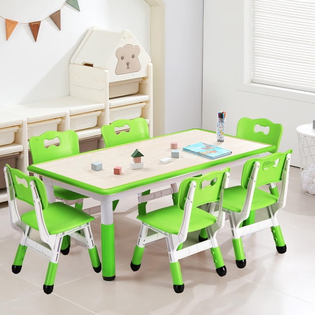 Kids Table and Chairs Set featuring a height-adjustable desk and six green chairs, designed for children aged 2-10. The table has a graffiti desktop and non-slip legs, with a weight capacity of 300 lbs. The chairs have curved backrests for ergonomic support and adjustable heights. The set is shown in a bright playroom setting with toys and art supplies on the table.