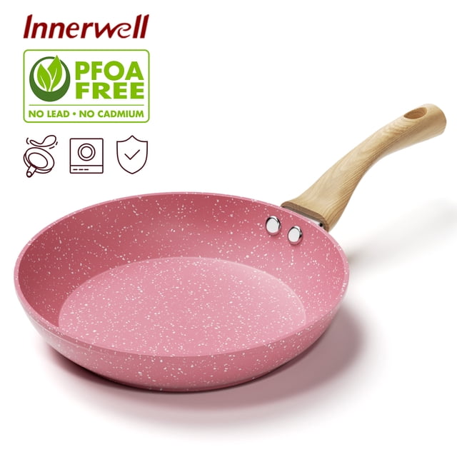 Innerwell 9.5 Inch Pink Nonstick Frying Pan Skillet with a speckled granite coating and a wood-grained bakelite handle. The pan features a toxin-free, ultra non-stick surface for easy cooking and cleaning, and a durable, fast-heating three-layer aluminum base. Suitable for various stoves, including induction, gas, and electric. The ergonomic handle remains cool during cooking, ensuring safe and comfortable use.