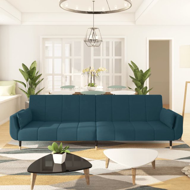 vidaXL 2-Seater Sofa Bed with Two Pillows in blue velvet fabric, shown in a modern living room setting. The sofa features a convertible design with adjustable backrests for sitting, lounging, or sleeping positions. It includes two matching pillows for added comfort and rests on sturdy wooden and metal legs. The velvet upholstery offers a soft and comfortable texture. Dimensions: 220 x 84.5 x 69 cm as a sofa and 220 x 100 x 52 cm when fully extended as a bed.