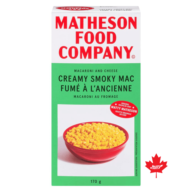 Matheson Macaroni and Cheese Creamy Smoky box with a front view of the 170 g package featuring a red bowl filled with creamy yellow macaroni and cheese on a green and white background, highlighting smoky bacon flavor and ideal for eating straight or baking into casseroles.