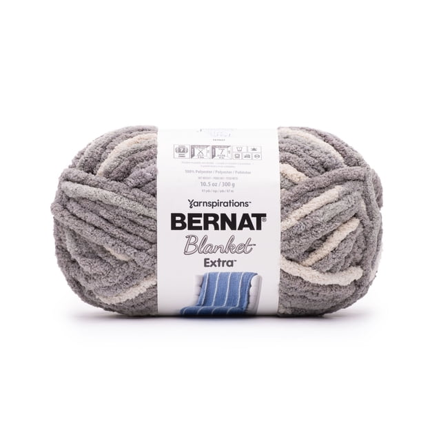Bernat® Blanket Extra™ Yarn jumbo #7 weight, 10.5oz/300g, 97 yards, soft chenille polyester skein in grey and cream tones, wrapped with a label showing brand, care instructions, and knitting gauge, ideal for machine washable home accent projects.