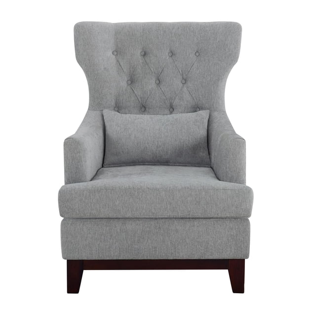 Topline Home Furnishings Accent Chair in grey with a wing-backed silhouette, button-tufted back, silver-toned nailhead trim, and matching lumbar pillow. Upholstered in neutral textured fabric with exposed espresso wooden legs, ideal for living room seating and accent décor.