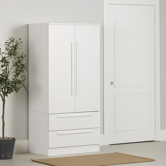South Shore Haven 2-Door Armoire with Drawers in pure white, a modern storage cabinet with clean lines, long vertical handles, two doors with adjustable shelves and a rod, above two spacious drawers, standing on a light floor next to a white door and a potted green plant, ideal for organizing coats and accessories in kids' rooms or entryways.