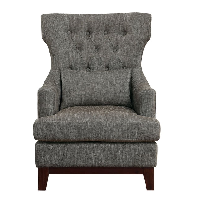 Topline Home Furnishings Accent Chair in brown-grey textured fabric with wing-backed silhouette, button-tufted back, silver-toned nailhead trim, matching lumbar pillow, fixed back, reversible seat cushions with removable cover, and espresso-finished exposed wooden legs, suitable for living room seating and accent décor.