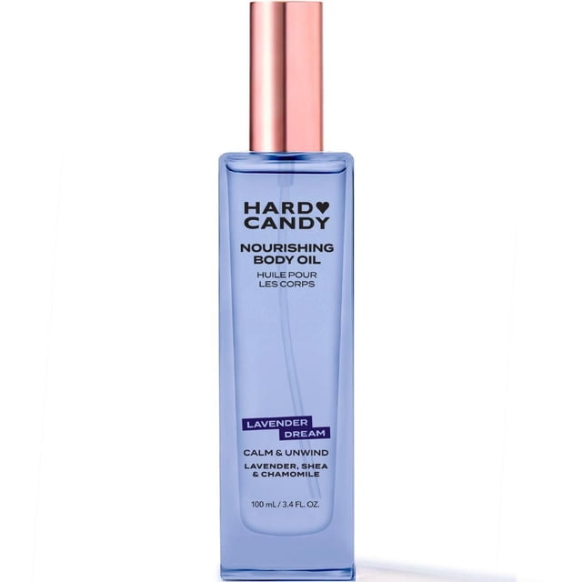 Hard Candy Nourishing Body Oil Lavender Dream in a translucent lavender rectangular bottle with rose gold pump, containing 100 ml of fast-absorbing body oil infused with lavender, shea, and chamomile to moisturize and calm skin, ideal for post-shower hydration or enhancing skin radiance.