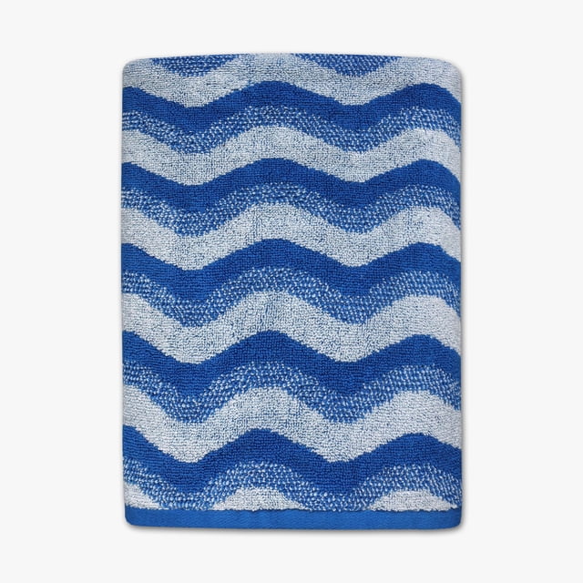 Mainstays Kids Bath Towel, Waves, folded to display blue and light blue wavy stripes, made from soft, absorbent 100% cotton, measuring 27 by 50 inches, ideal for kids' bathroom use and beach days, often used as a cozy drying towel after swimming.