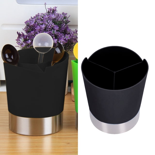 Oleegame 1PC Spoon And Lid Rest and 1pc Straw Dispenser with a stable base, made of premium plastic and stainless steel. Features a black cylindrical design with three compartments for organizing coffee stirrers, spoons, or straws. Suitable for home, restaurant, or bar use. Displayed on a wooden countertop with a purple floral arrangement in the background.