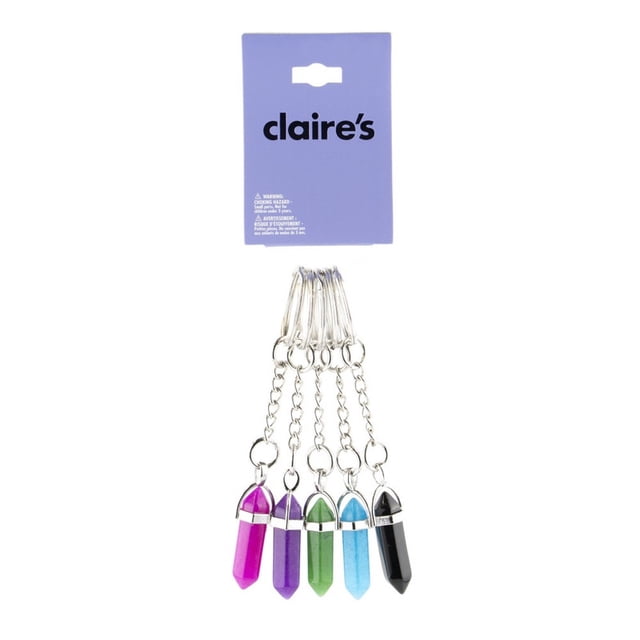 Claire's Teenagers Crystals Best Friends Keychains, a 5-pack set featuring crystal-shaped keychains in black, blue, green, purple, and pink. Each keychain includes a silver chain and ring for holding keys or trinkets. Packaged on a purple Claire's branded card, this set is ideal for sharing with friends or gifting for occasions like birthdays or back-to-school.