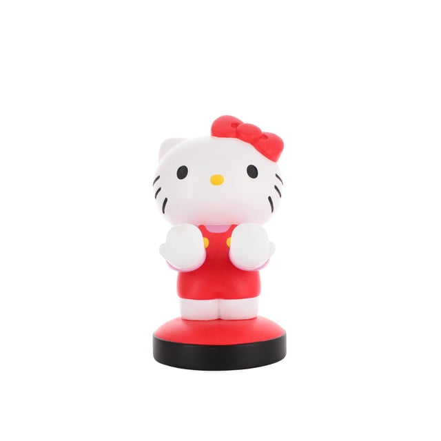 Exquisite Gaming Sanrio: Hello Kitty Cable Guy Controller Holder and Phone Stand with a front-facing white Hello Kitty figure wearing a red dress with yellow buttons and a red bow on the left ear, standing 8 inches tall on a round red and black base, compatible with most smartphones and gaming controllers, also suitable as a decorative desk accessory.