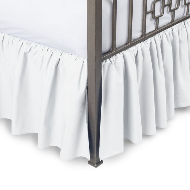 Cotton Metrics Linen Gathered Dust Ruffle Bed Skirt made from 100% organic cotton with an 800 thread count. The image shows a white ruffle bed skirt with a 13-inch drop length, elegantly draped around the base of a bed frame. This bedding accessory is crease-resistant, durable, and suitable for bedroom decor in various room styles.