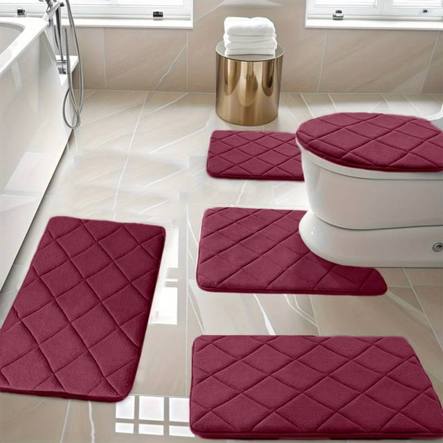 Ycandiee Bathroom Rug Set 5 Piece, featuring soft, non-slip memory foam bath mats in a burgundy color. The set includes a toilet lid cover, a U-shaped counter rug, a small bathroom rug, and two large bath rugs. Designed for water absorption and comfort, these mats have a quilted texture and PVC non-slip backing for safety. Displayed in a modern bathroom setting with tiled floors and natural light.