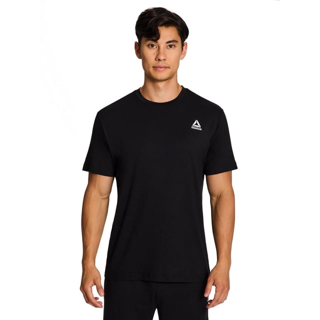 Reebok T-Shirt à Manches Courtes Delta Core pour Homme en Noir, Vue avant d'Un Modèle Masculin. Fabriqué en Tissu jersey Doux Qui Évacue l'Humidité avec Col Ras du Cou et Manches Courtes, Offre un Haut Ajusté du Torse et une Section Médiane Décontractée pour le Confort. Présente le logo Delta Reebok Blanc sur la Poitrine Gauche, Convient aux Entraînements Ou aux Tenues Décontractées.