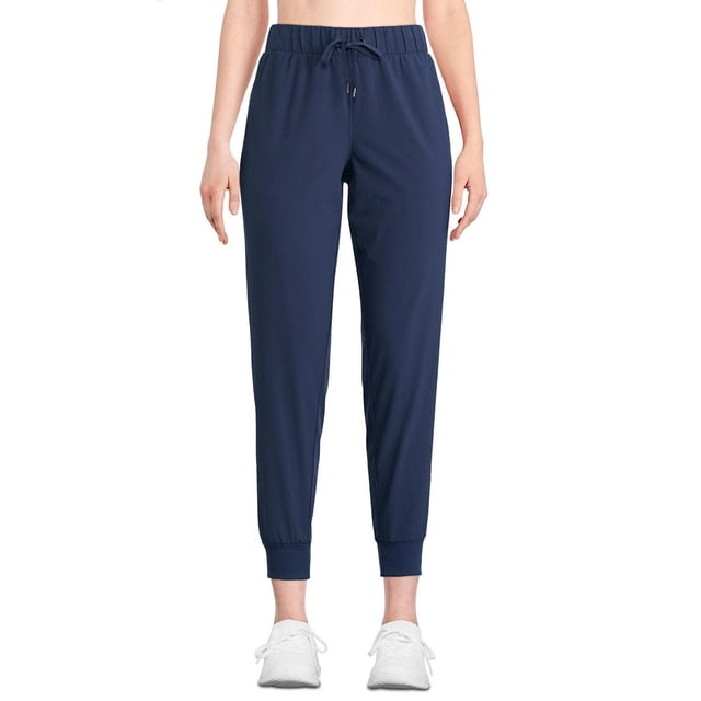 Athletic Works Women's Ribbed Cuff Woven Pant in navy blue, front view with elasticized waistband and drawstring, two jetted pockets, and ribbed ankle cuffs, made of stretch woven fabric with DRI-MORE moisture-wicking technology, ideal for jogging or casual wear.