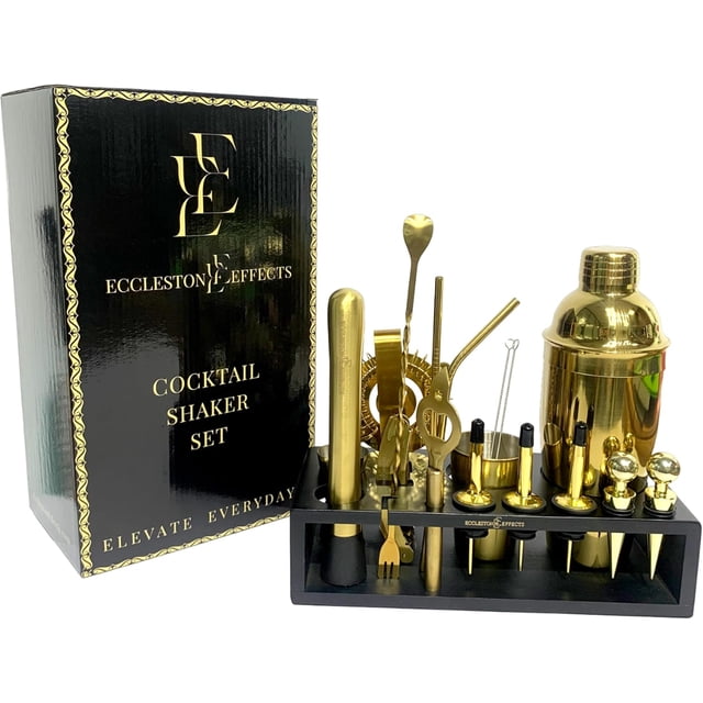 18 Piece Bar Cocktail Shaker Set with Stylish Bamboo Stand (Gold) by Eccleston Effects. This premium set includes a gold stainless steel shaker with a 340ml capacity, built-in strainer, muddler, tongs, bottle opener, and 6 interchangeable shot glasses. The set is displayed on a sleek black bamboo stand, keeping tools organized and accessible. Ideal for home mixology and entertaining, this set combines functionality with elegance, making it a great gift for cocktail enthusiasts.