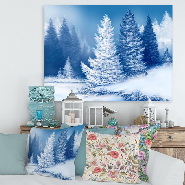 Designart Dreamlike Spruce Forest With Snow Covered Trees Canvas Wall Art is a gallery-wrapped cotton canvas print depicting a blue and white snowy spruce forest, stretched over a wood sub frame and ready to hang, ideal for adding a serene landscape touch to home décor.