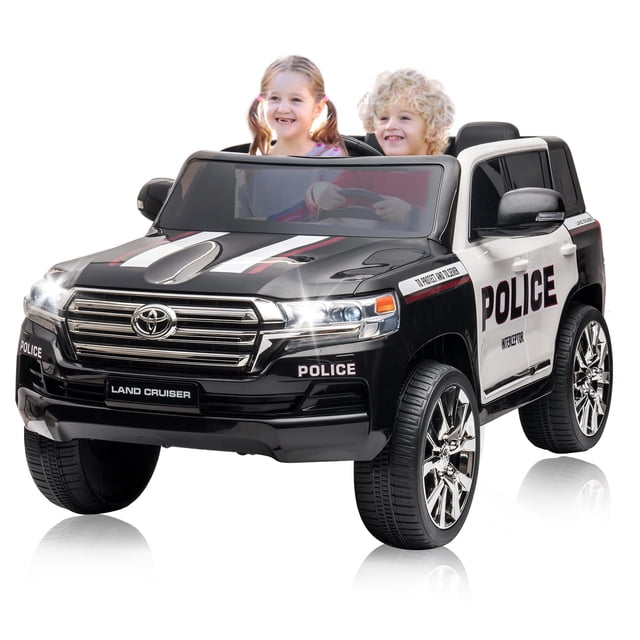 AKDSteel Kids Ride On Car, Licensed Toyota Land Cruiser with a black and white police-themed design, powered by a 12V 7Ah battery with dual motors and 3-speed parent remote control. This powered ride-on toy features a 16-inch bench seat for two children, lockable doors, adjustable seat belts, and soft-start wheels for safety. Includes LED headlights, spring suspension, music, horn, and engine sounds for an exciting remote-controlled outdoor play experience.