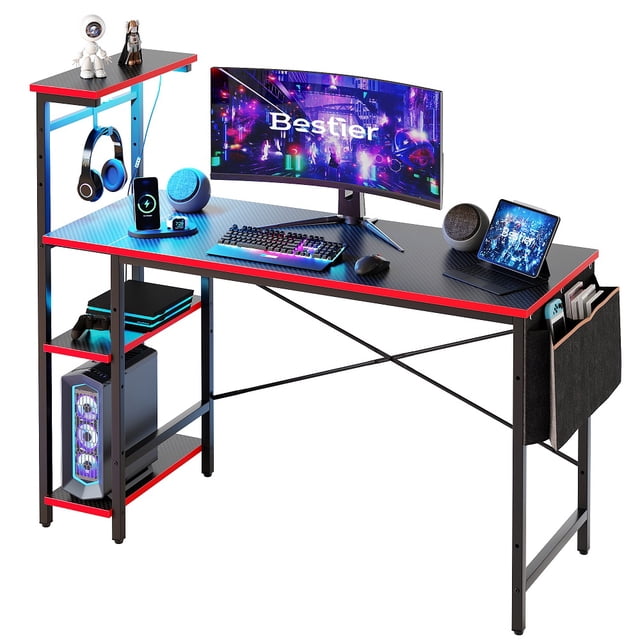 Bestier 52 inch Gaming Computer Desk with LED Lights & Shelves, featuring a carbon fiber surface, reversible 4-tier shelves, and an X-crossbar metal frame for stability. The desk includes a headphone hook, side storage bag, and adjustable shelves. The LED lights offer 7 color options and 22 dynamic modes, controlled via remote. Suitable for gaming, studying, or office use, with ample space for monitors, laptops, and accessories. Dimensions: 51.3 inches L x 19.7 inches W x 44.7 inches H.