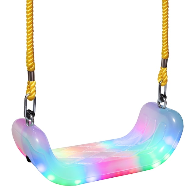 XDP Recreation 75115 Outdoor Kids Firefly LED Tree Swing with a semi-clear polypropylene seat illuminated by 24 multicoloured LED lights. Includes yellow ropes and metal chains for adjustable length, suitable for children aged 3 and older, up to 150 pounds. Motion-activated strobing lights offer 7 modes and 8 colours, powered by 3 AA batteries (not included). Ideal as a swing set accessory for outdoor play.