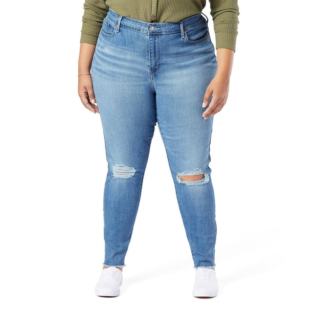 Levi Strauss Signature.™ Red Women's Plus High Rise Skinny Jeans in light blue denim with distressed knee rips, high-rise waist, skinny leg fit, zip fly, and five-pocket styling, worn with white sneakers and olive green ribbed top, front view on white background, ideal for casual or dressy occasions.