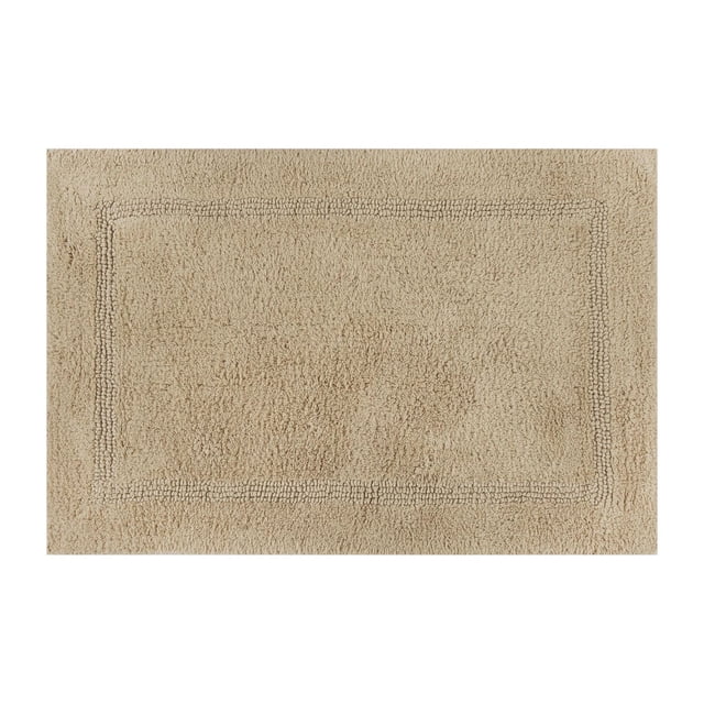 Better Homes & Gardens Cotton Reversible Bath Rug in Almond Biscuit, 17" x 24", featuring a soft, absorbent 100% cotton texture with a subtle rectangular border pattern, machine washable and suitable for bathroom floors or as a comfortable standing mat.
