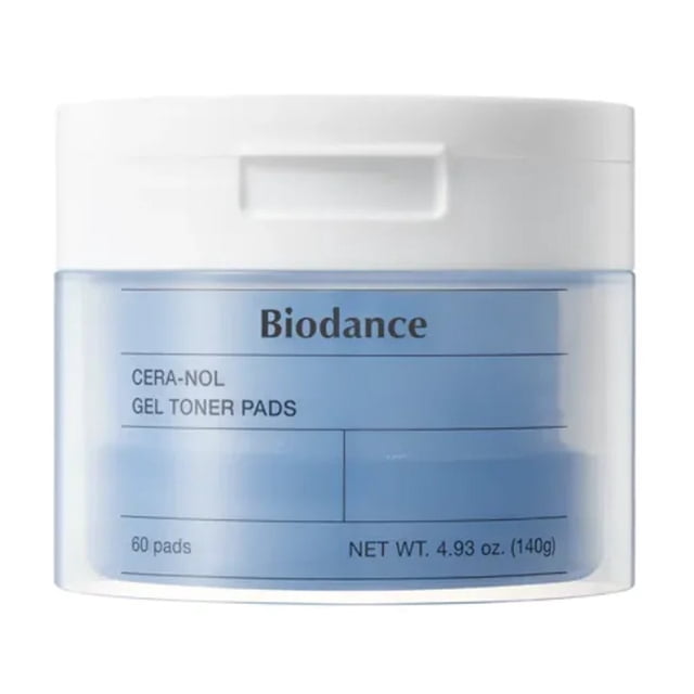 BIODANCE Cera-nol Gel Toner Pads, a container of 60 pads designed for dry and sensitive skin. The jar features a white lid and a transparent body showcasing the blue gel pads inside. Infused with D-Panthenol, ceramides, and a 10-layer hyaluronic acid complex, these pads provide hydration and soothing care. The label highlights the product name and net weight of 4.93 oz (140g).