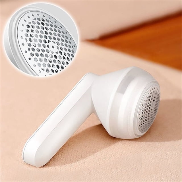 Sweater Fuzz Remover Fabric Shaver Electric Lint Remover Rechargeable Fabric Shaver in a white finish with a honeycomb-style stainless steel blade cover. The ergonomic handle and compact design make it suitable for removing lint, fuzz, and pet hair from clothing and fabrics. A close-up inset highlights the blade guard for safe operation.