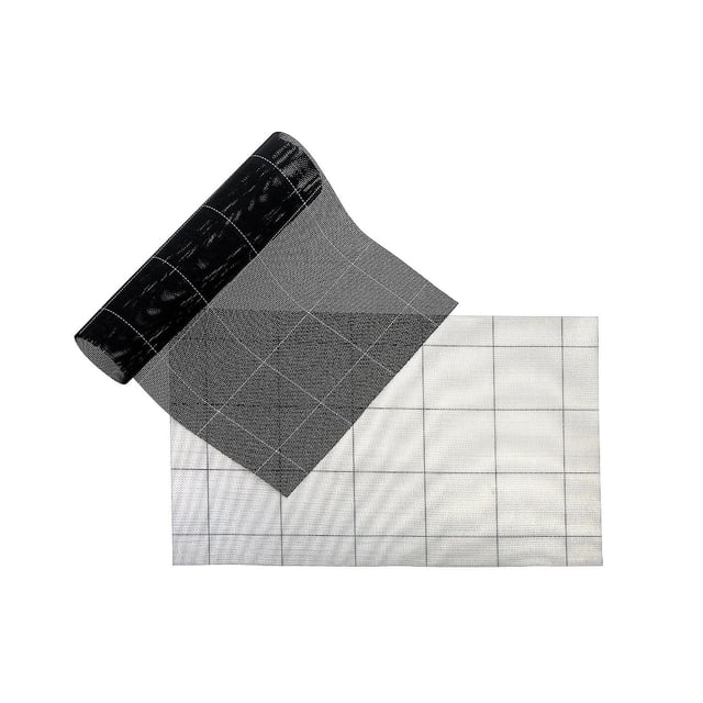 Woven Pvc Placemat Set Of 4 Square Block White/Black showing a close-up of one placemat partially rolled over another, with a black and white square block woven pattern. These durable PVC placemats protect dining tables from spills and heat while adding modern style, also suitable for craft or workspace surface protection.