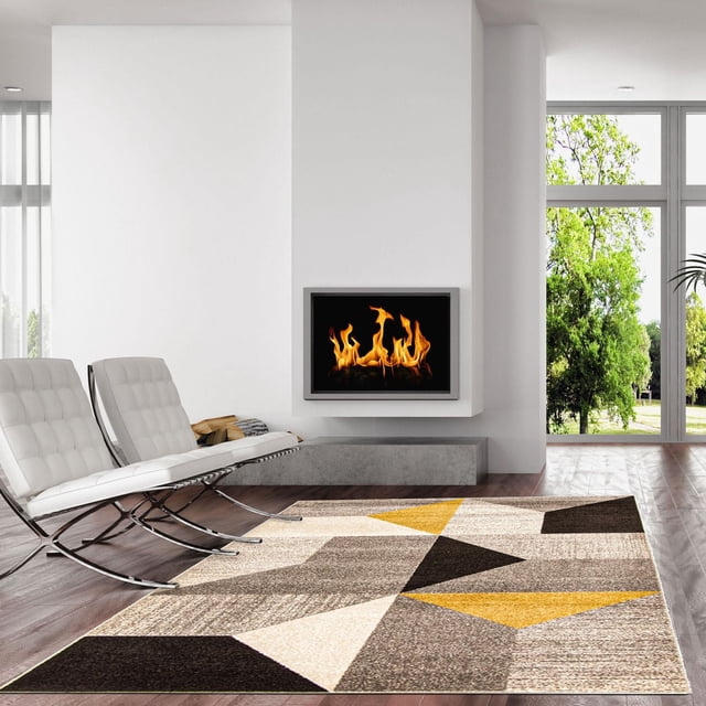 ECARPET Geometric Area Rug from the Harlow Collection featuring bold geometric patterns in beige, brown, black, and yellow, placed on hardwood flooring in a modern living room with white leather chairs and a wall-mounted fireplace, ideal for enhancing indoor comfort and style.
