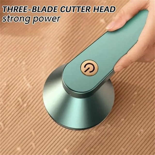 Sweater Fuzz Remover Fabric Shaver Electric Lint Remover with a sleek green handle and gold power button, featuring a three-blade cutter head for strong performance. Rechargeable and USB fast charging, the device is shown in use on a ribbed fabric surface, effectively removing lint and fuzz.