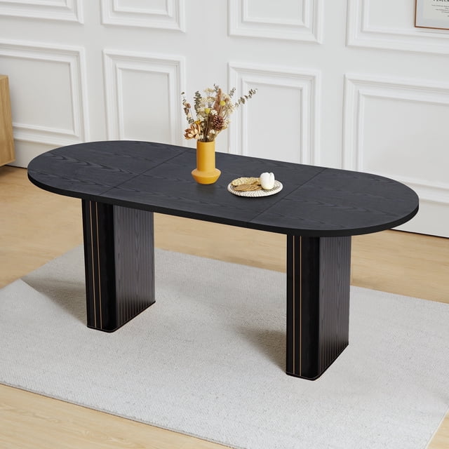 70.8 Inch Dining Table for Rustic Farmhouse, Oval Kitchen Dining Room Table with Wooden Base in black. The table features a smooth, oval-shaped MDF tabletop with a wood veneer finish, supported by a sturdy wooden base. Measuring 70.86 inches in length, it comfortably seats 6-10 people, making it ideal for dining rooms, meeting rooms, or reception areas. The table is shown in a modern interior setting with a light rug and decorative items on top.