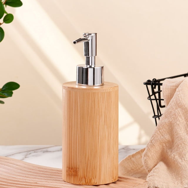 TIMIFIS Bathroom Organizer Soap Dispenser, a refillable liquid soap and lotion dispenser made of durable wood material in a khaki finish. The dispenser features a sleek stainless steel pump for easy dispensing and a natural, modern design. Ideal for use in bathrooms or kitchens, it can hold hand soap, liquid soap, or lotion. The dispenser is shown on a marble countertop with a beige background and nearby decorative elements.