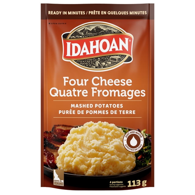 Idahoan Four Cheese Mashed Potatoes pouch in brown packaging featuring the Idahoan logo, containing 113 grams of instant mashed potatoes made with cheddar, bleu, romano, and parmesan cheeses, ready in minutes by adding water, ideal for a quick potato side dish.
