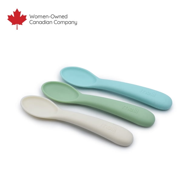 Silicone Spoons - 3pk with three toddler-friendly spoons in pastel blue, green, and cream, made from soft, food-grade silicone with easy-grip handles embossed with Melii, ideal for encouraging self-feeding and gentle on sensitive gums, displayed on a white background alongside a Women-Owned Canadian Company logo.