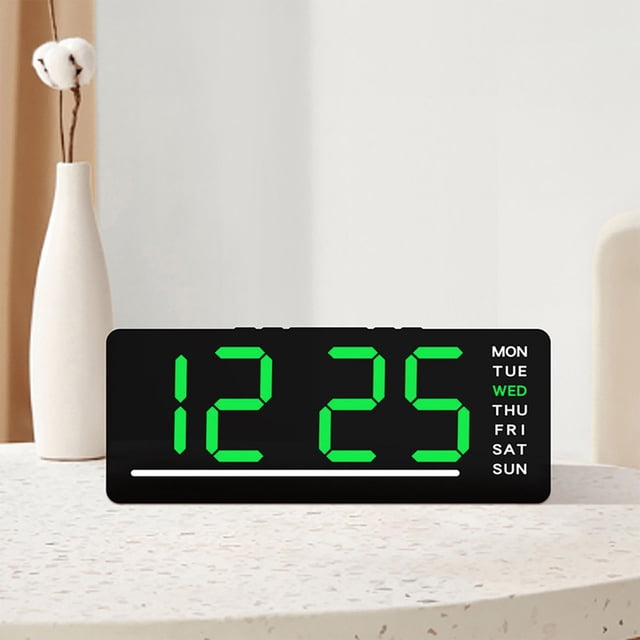 CQCYD Digital Alarm Clock with a sleek black plastic casing, featuring a bright green LED display showing the time '12:25' and the day 'Wednesday' highlighted on the right. The clock includes multi-functional features such as date, temperature display, and brightness adjustment. It is powered by either 3 AAA batteries or an electric charging cable, making it suitable for bedside or desk use. The compact design measures 6.1 x 2.48 x 0.98 inches.