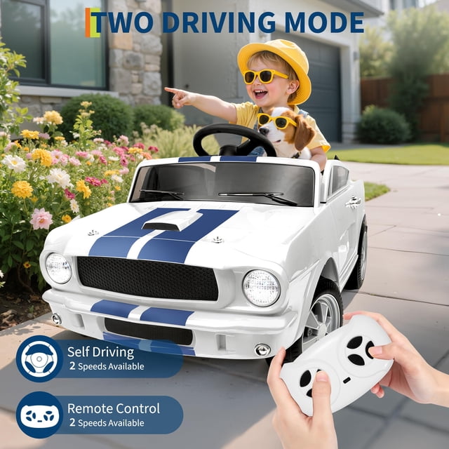 BeesClover Ride on Car for Toddler, a 12V licensed Shelby electric vehicle with Bluetooth connectivity and a built-in media player for entertainment. The car features a sleek white design with blue racing stripes, functional headlights, secure doors, and a 3-point harness for safety. It offers two driving modes: self-driving for kids and parental control via remote. A child wearing a yellow hat and sunglasses is seated in the car with a dog, enjoying the ride in a sunny outdoor setting. The remote control is held in the foreground, highlighting the dual control functionality.