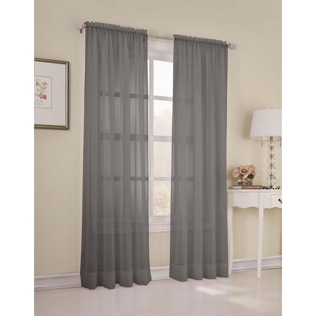 SUN TEXTILE VOILE ROD POCKET CURTAIN in sheer voile fabric hanging on a silver rod over a window in a beige room, gently filtering light and enhancing privacy, suitable for layering with other curtains