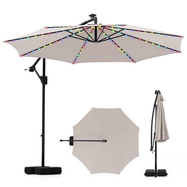Costway 10 FT Solar Offset Hanging Umbrella with 96 Solar Multi-colored Flowing LED Lights in beige. Features a double-tier polyester canopy with sun protection and water resistance, supported by 8 metal ribs and a cross base with 2 sandbags for stability. Includes 96 LED lights with 9 lighting modes powered by a solar panel, offering static and dynamic options. The umbrella provides 360° rotation and infinite tilt for customizable shade, with a crank handle for easy operation. Suitable for backyards, poolside, and outdoor dining spaces.