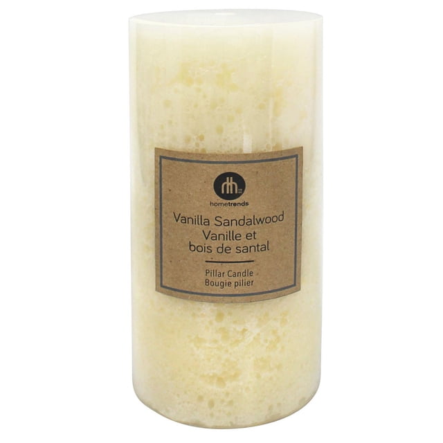 Hometrends 6" Vanilla Sandalwood Scented Pillar Candle with ivory wax and cotton wick, 3 inches diameter by 6 inches height, textured surface, and brown bilingual label, ideal for indoor Christmas decoration and creating warm ambiance.