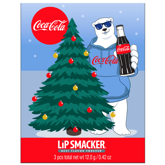Coca-Cola Holiday Lip Balm Storybook with a decorated Christmas tree featuring red and gold ornaments beside a figure wearing a blue Coca-Cola hoodie holding a classic glass bottle of Coca-Cola, set against a snowy light blue background, capturing festive holiday and Coca-Cola branding.