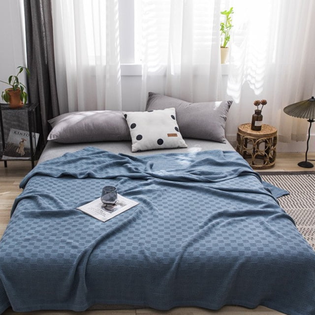 Oefntac Savings Cotton Bed Blanket Twin Cotton Thermal Blanket in blue, displayed on a neatly made bed in a bright, modern bedroom. The lightweight bed throw features a subtle checkered texture and measures 200x150cm. Suitable for all seasons, it is soft, comfortable, breathable, and machine washable.