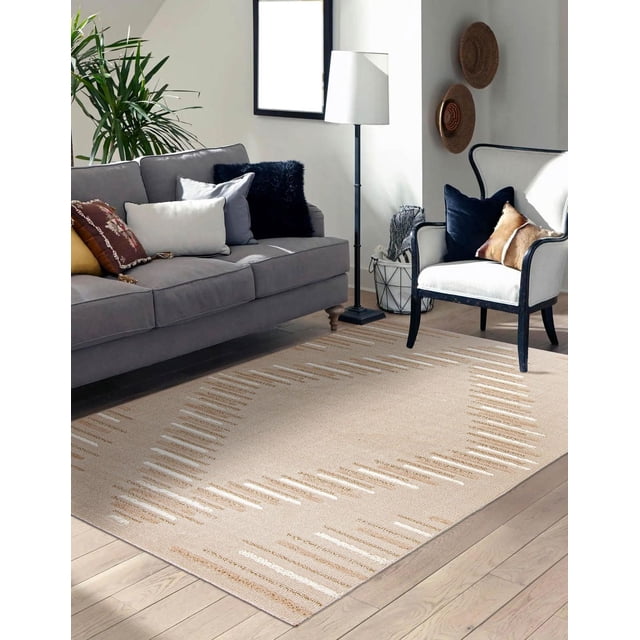 ECARPET Jute Style Area Rug for Bedroom, Living Room, Dining Room Santee Collection in a bright living room with light hardwood floors. The beige rug features a geometric high-low textured pattern in natural jute and white tones. It is placed under a gray sofa with assorted cushions and a white armchair with dark wood trim and pillows. The rug’s dense looped pile offers plush texture and stain resistance, ideal for various home spaces.