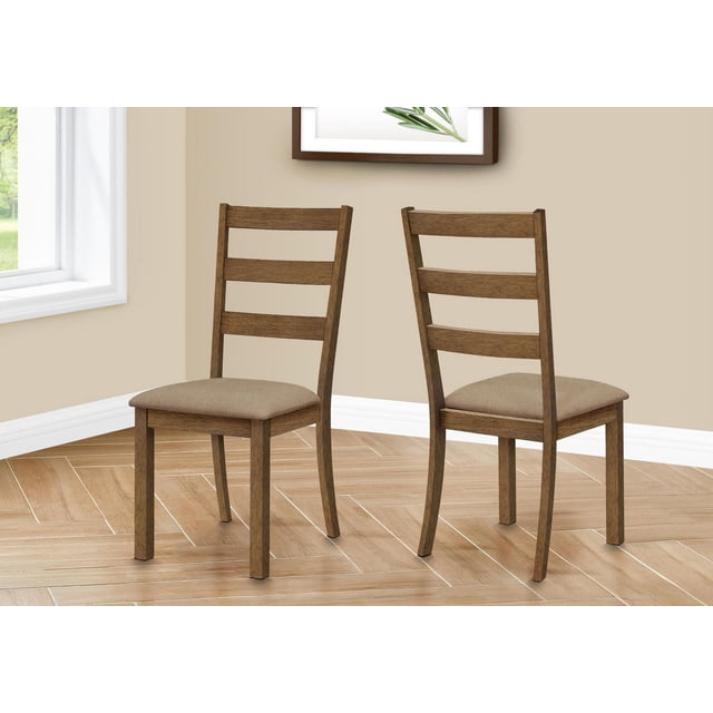 Monarch Specialties Dining Chair set of 2, side view, upholstered in beige fabric with thick padding, walnut wood grain finish, open ladder back frame, straight front legs and curved back legs, on light wood herringbone floor in a beige dining room corner with white baseboards and a window, suitable for casual or formal dining settings.