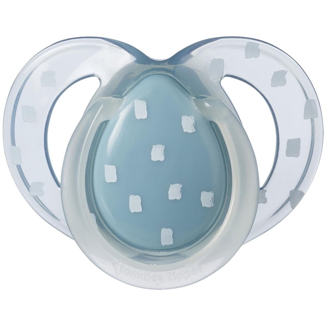 Tommee Tippee Night Time Glow in the Dark Pacifier with symmetrical blue BPA-free silicone nipple and clear shield decorated with white squares, designed for 6-18 months, includes a reusable sterilizer pod for microwave use and a glow-in-the-dark handle for easy nighttime finding.