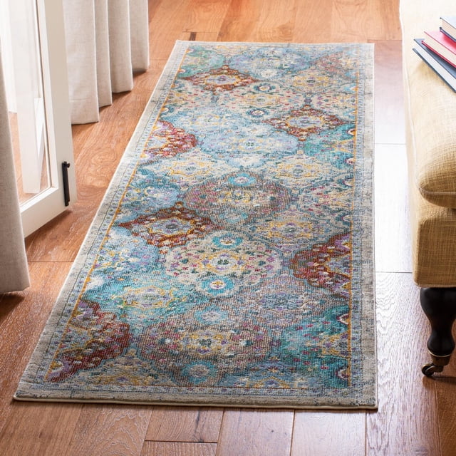 SAFAVIEH Luxor Harry Abstract Floral Area Rug runner featuring a multicolored abstract floral pattern in blue, teal, red, yellow, and beige, hand-knotted viscose yarns with a classic Egyptian weave, placed on hardwood flooring beside a beige sofa and near a glass door with curtains, ideal for adding exotic elegance to home décor.