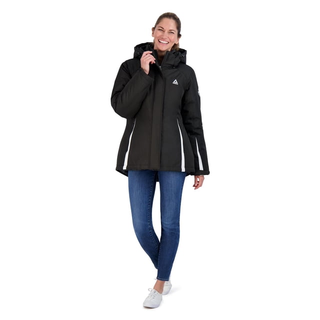 Reebok Ski Jacket in black with white vertical side stripes, featuring a hood, front zipper closure, and multiple pockets for winter activities, worn with blue jeans and white sneakers in a full-length front view on a white background.