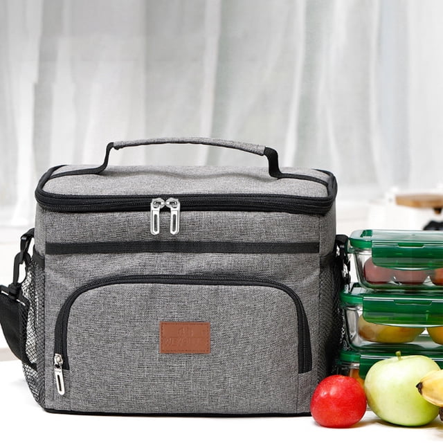 Insulated Leakproof Soft Cooler Bag with 36L capacity in gray, shown in a front-facing view. The bag features a durable cloth exterior, a zippered main compartment, a front pocket with a zipper, and mesh side pockets. It measures 29x24x22 cm and includes a comfortable handle for portability. The image also shows the bag placed on a table with fruits and food containers nearby, highlighting its use for lunch, groceries, camping, and road trips.